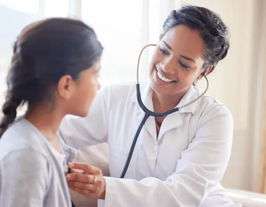 Primary Care Pediatric Nurse Practitioner Taking Heart Rate of Child Patient